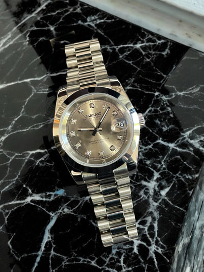 Gold watch on a black marble surface
