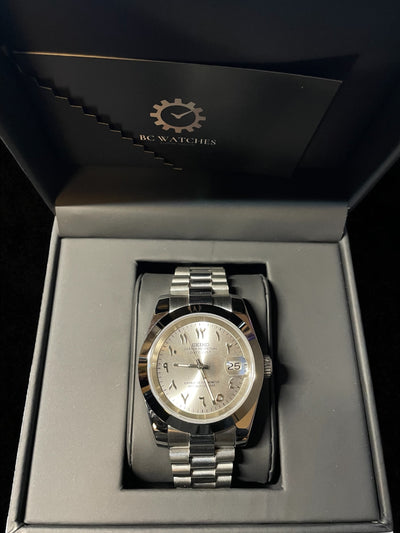 Silver watch in a black box with 'BC Watches' branding.