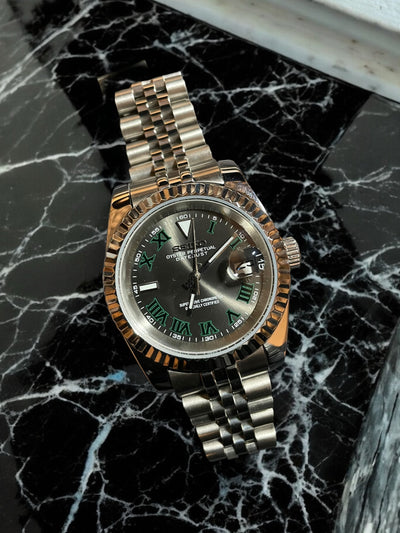 Luxury watch with a silver and gold band on a black marble surface