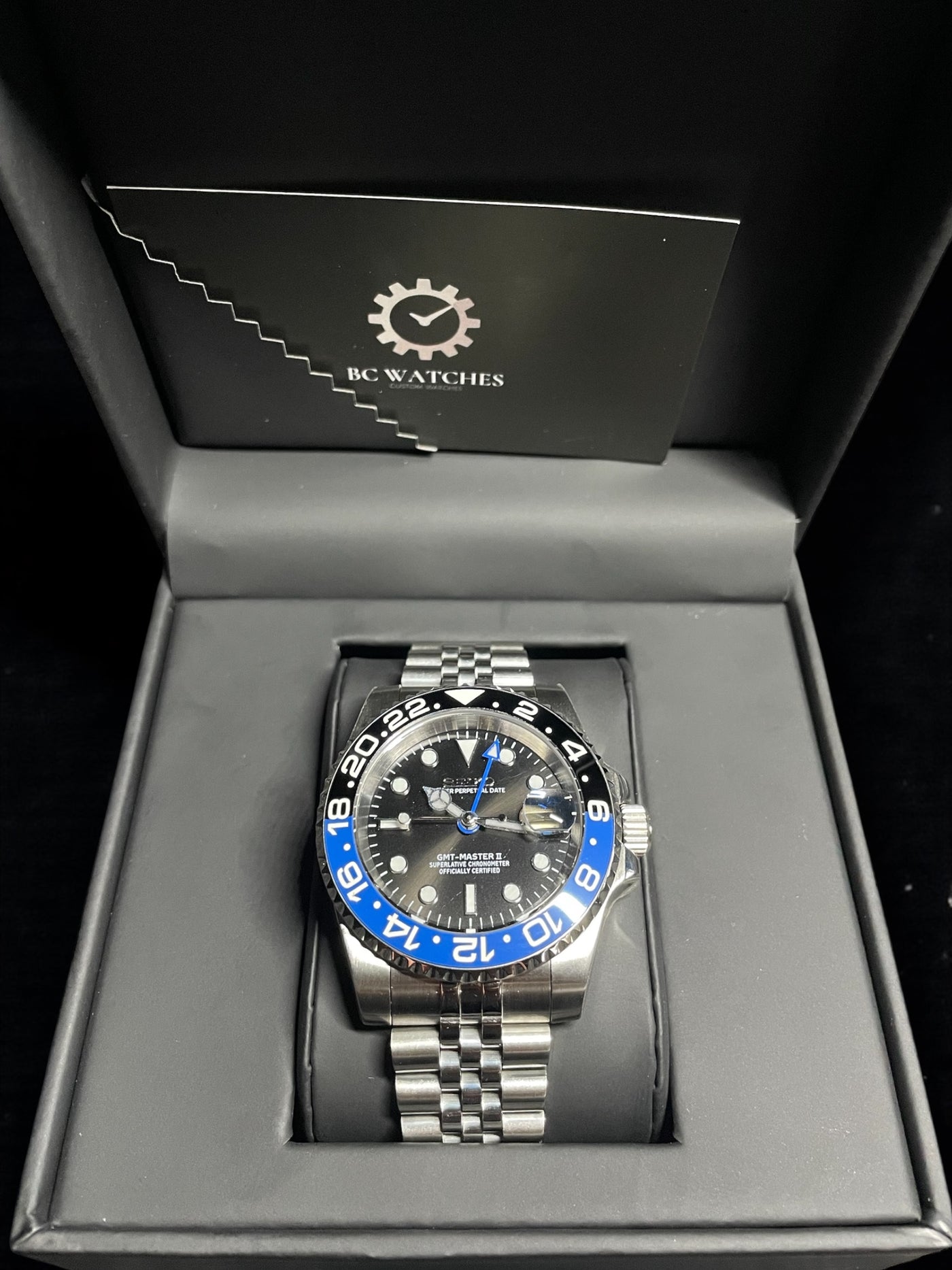 Wristwatch with blue accents in a branded box
