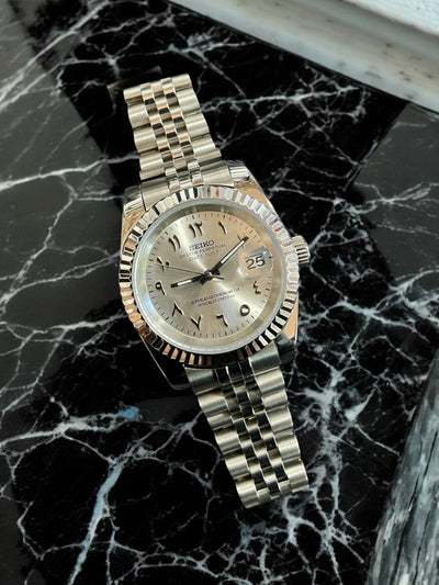 Silver watch on a black marble surface